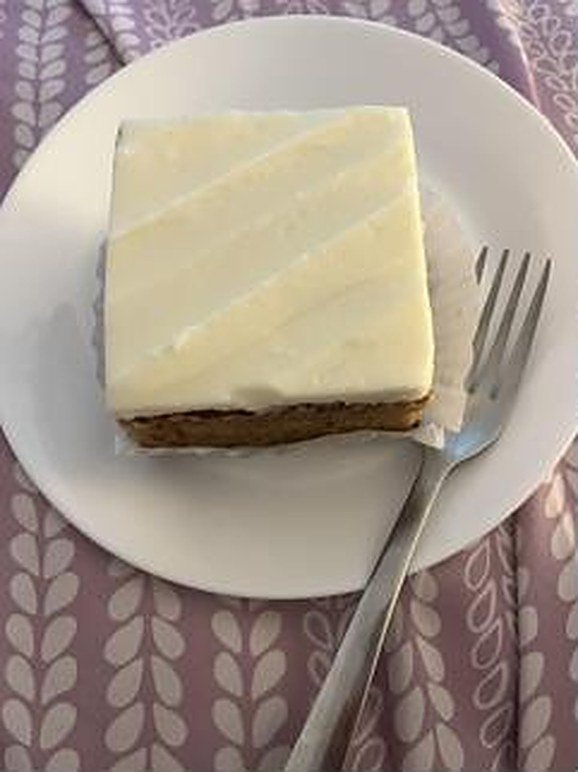 Slice of carrot cake with cream cheese frosting